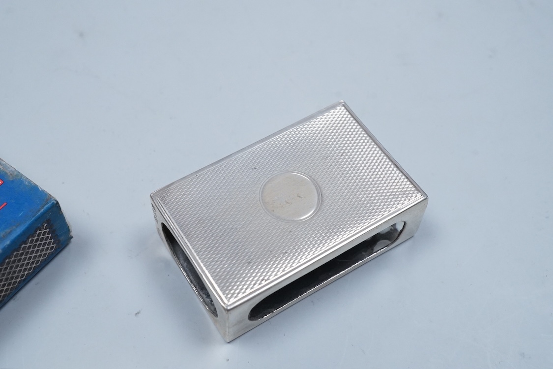 A George V engraved silver cigarette case, Birmingham, 1930, 82mm, a similar silver vesta case, London, 1913 and two silver matchbox sleeves.